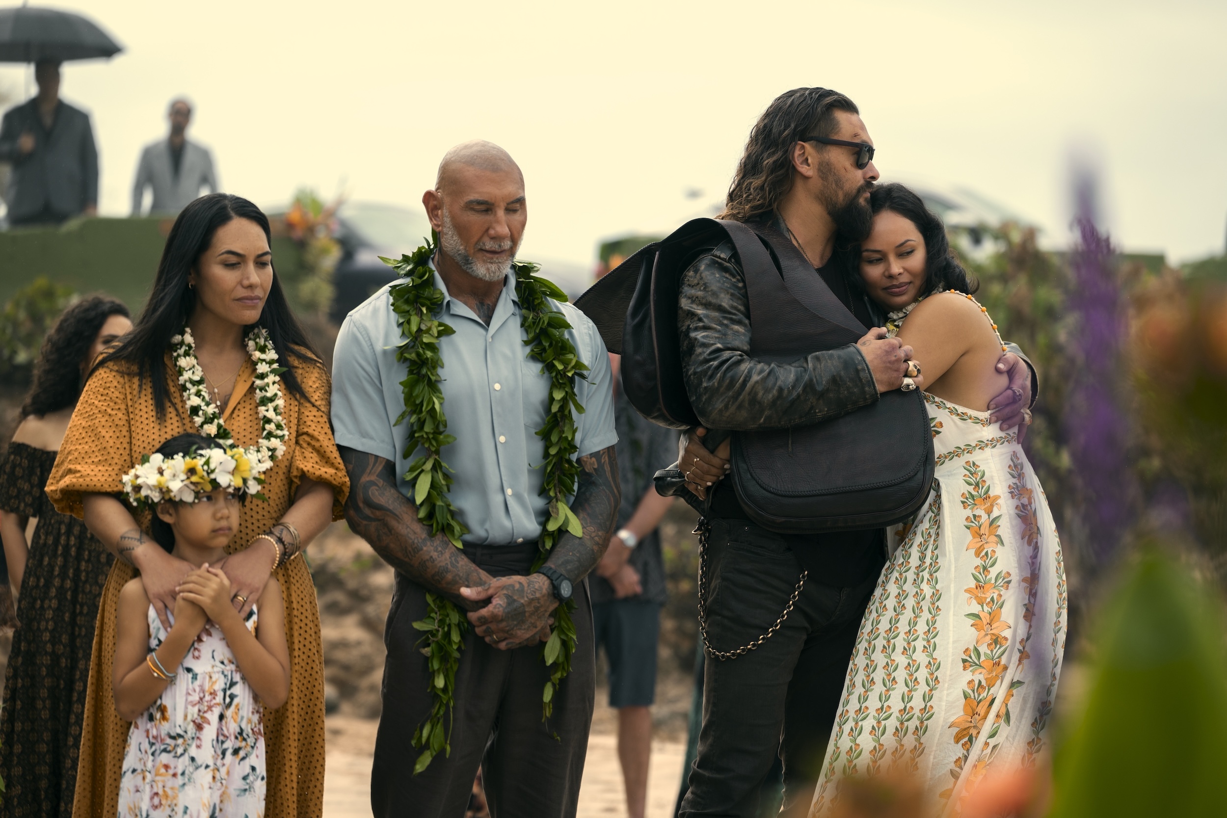 The funeral held at the beach is the first scene where we see Nani, far right, played by Frankie Adams. She embraces her long lost cousin, Jonny, played by Jason Momoa.
