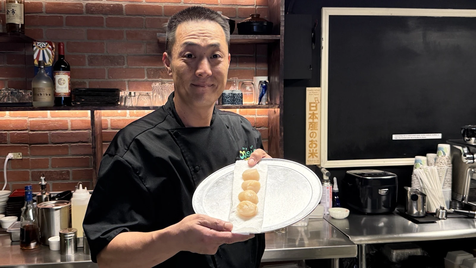 Chef Ken Maeda holds up Hokkaido scallops