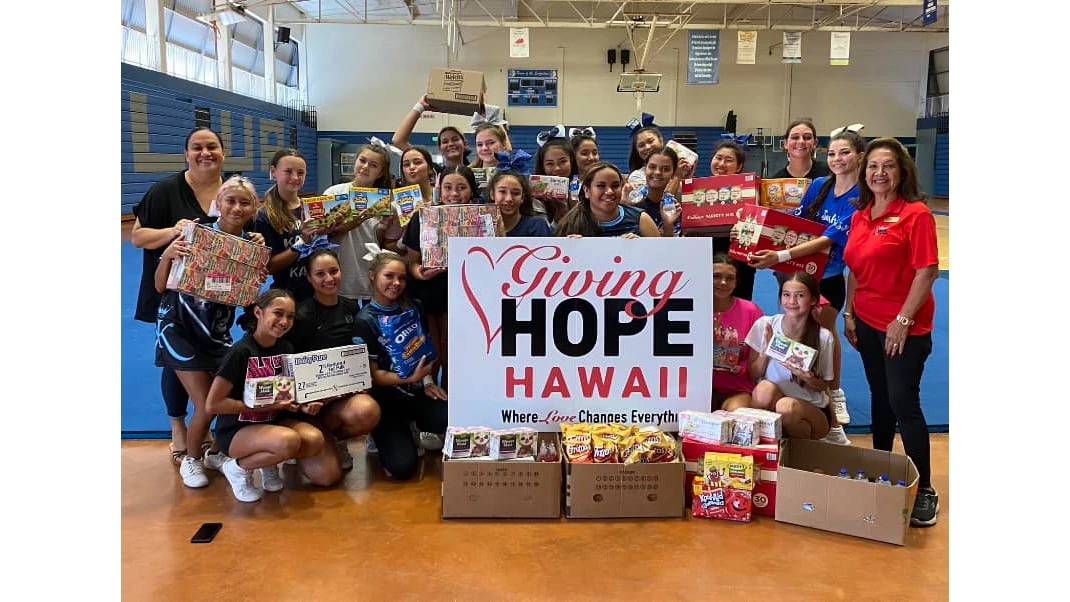 Group of high schoolers with a sign for Giving Hope Hawaii.