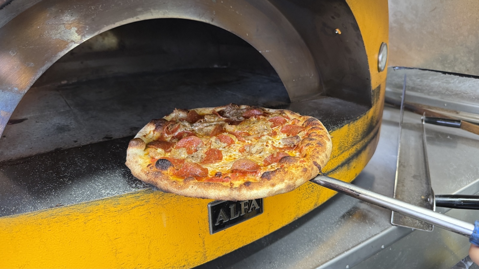 pizza going into oven