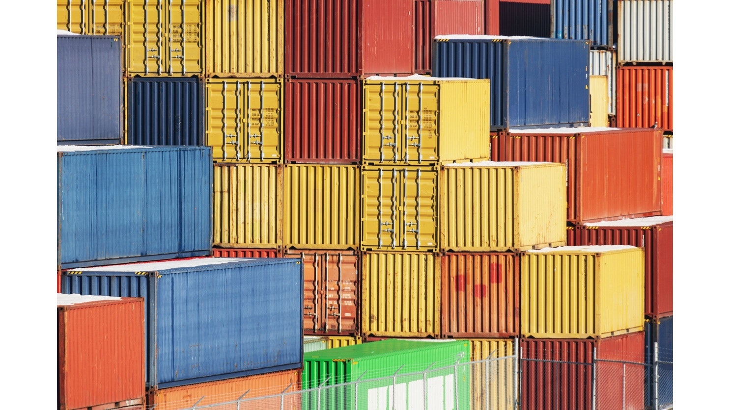 Photo of shipping containers piled high.