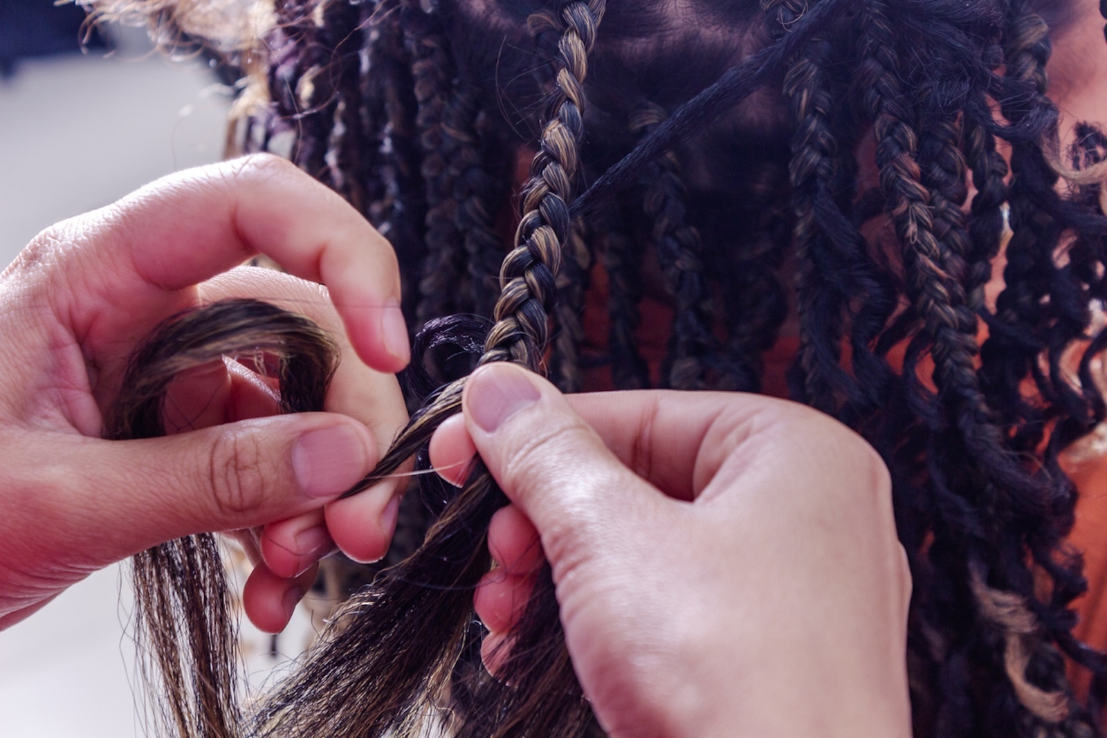Hair braider in the beauty salon