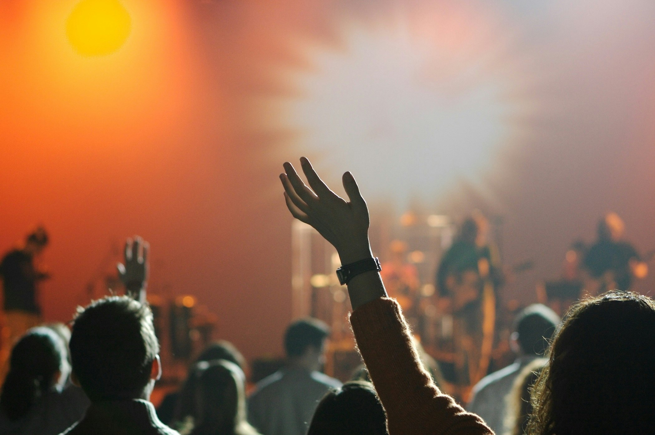 Photo of a woman raising her hand during worship.