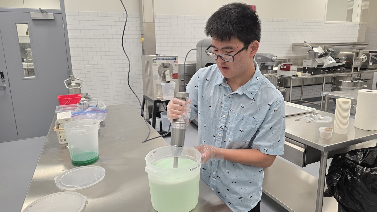 Kenny Tsuru, a Pearl City High School senior and owner of Kenny Boy Ice Cream, works on a batch of his Melono ice cream Feb. 18 at the Wahiawā Value-Added Product Development Center.