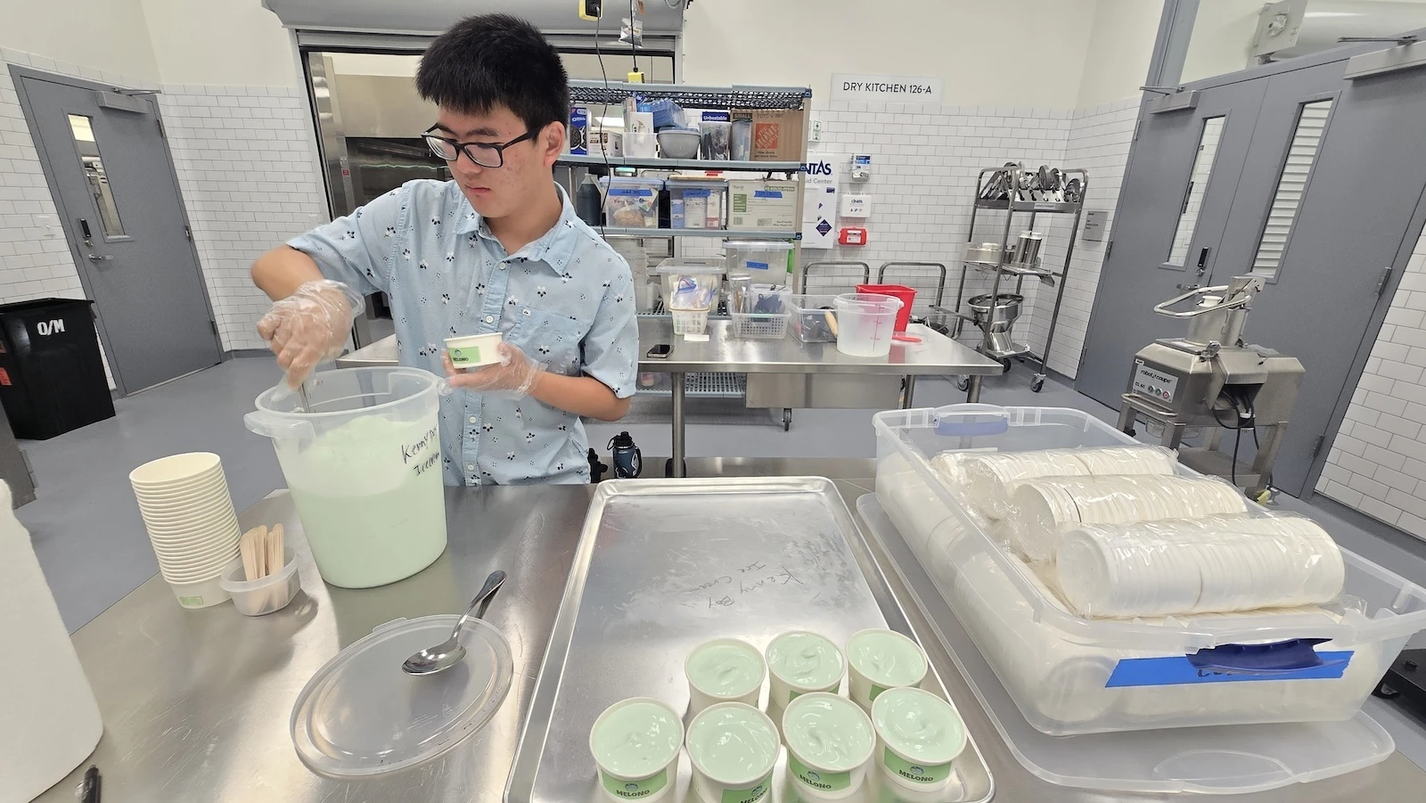 Kenny Tsuru, the name and driver behind Kenny Boy Ice Cream, packages his Melono ice cream.