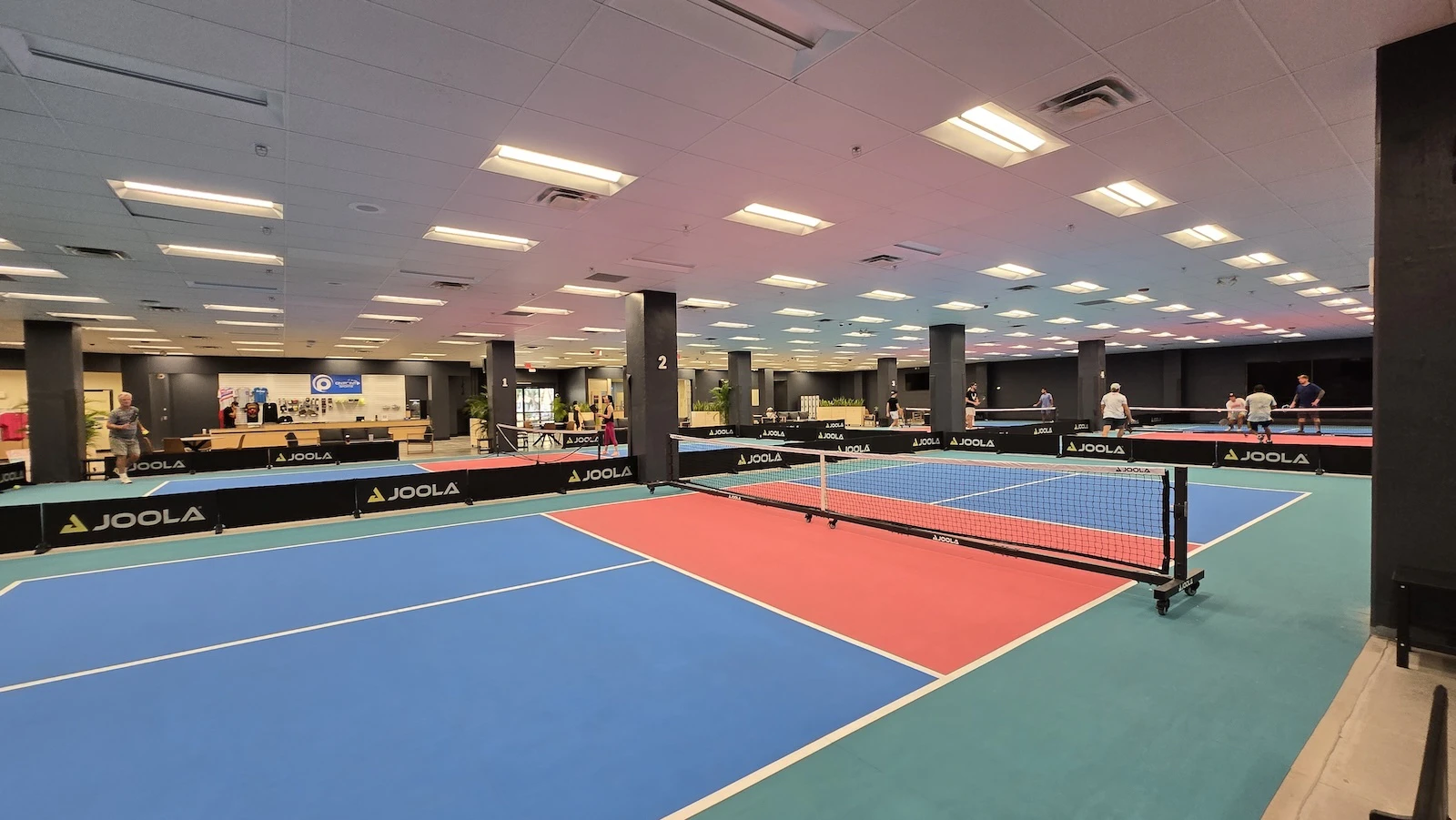An interior shot of the pickleball court at Pickles on Forté.