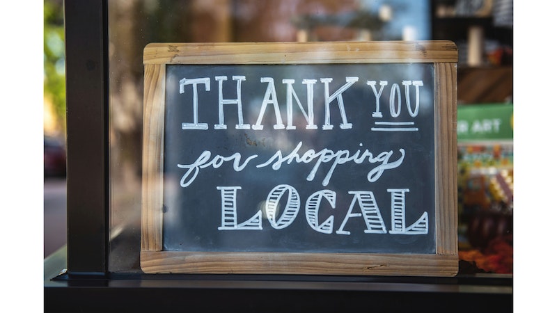 A 'thank you for shopping local' sign.