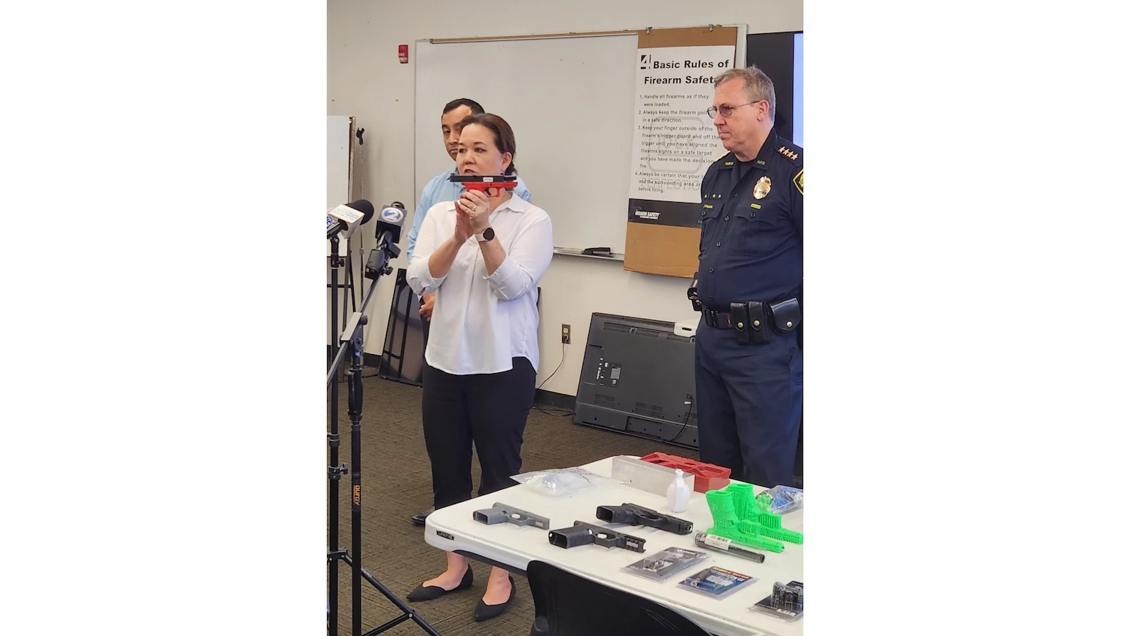 Rep. Jill Tokuda holding a pistol