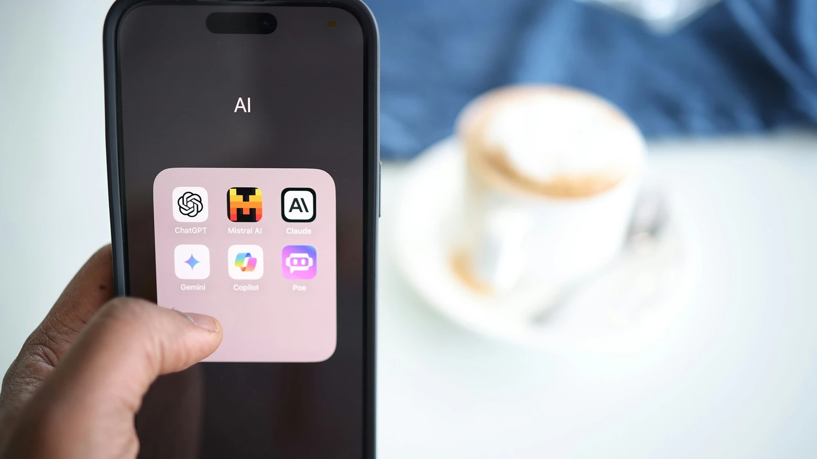 A person holding a cell phone with AI apps.