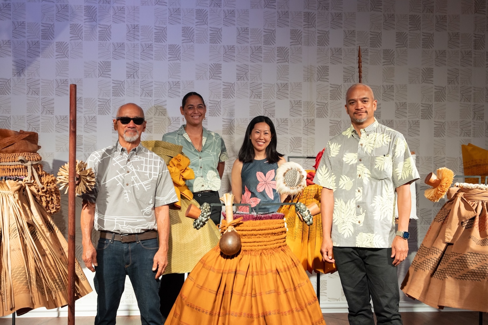 From left to right, artists Sig Zane and Kūhaʻoʻīmaikalani Zane (front row) stand with co-curators Kauʻi Kanakaʻole and Sarah Kuaiwa (back row).