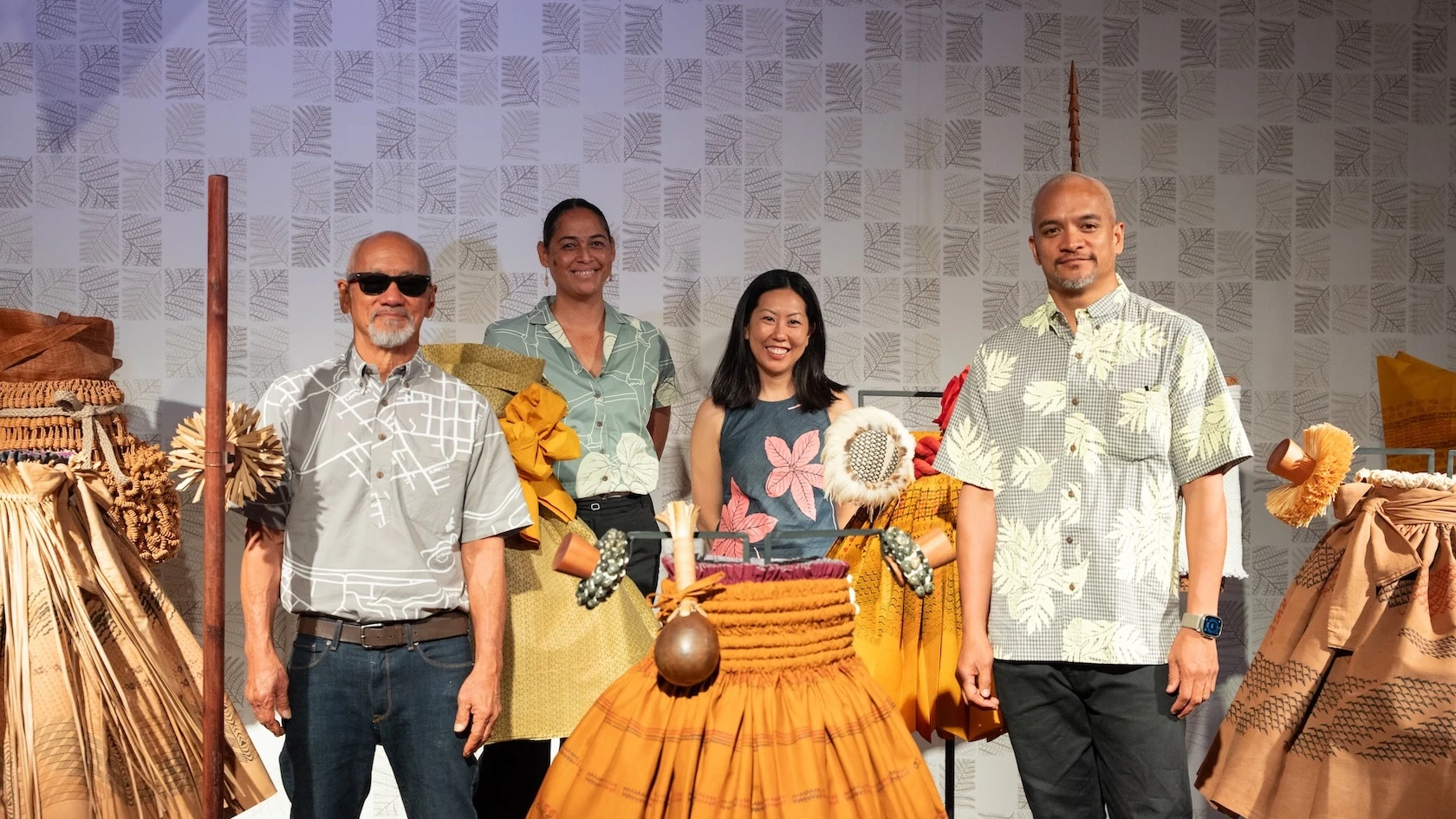 From left to right, artists Sig Zane and Kūhaʻoʻīmaikalani Zane (front row) stand with co-curators Kauʻi Kanakaʻole and Sarah Kuaiwa (back row).