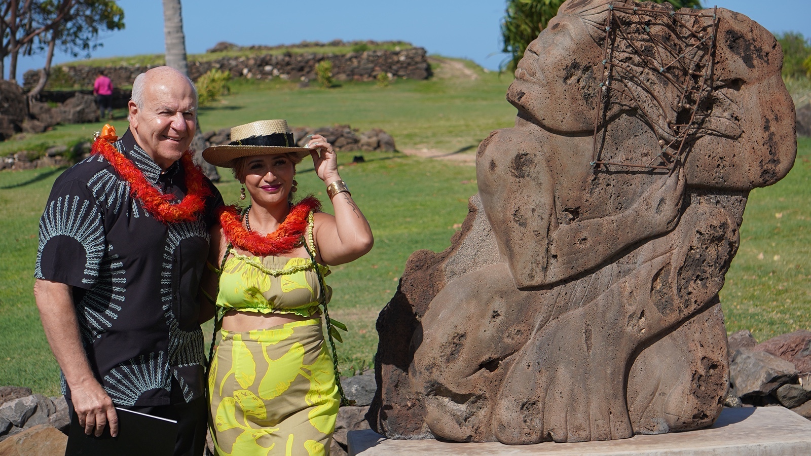 Honolulu City Mayor Rick Blangiardi and Kingdom Pathways co-founder Carmen Guzman-Simpliciano stand beside basalt stone Kumu sculpture, Nā Ho'okele, on August 28.