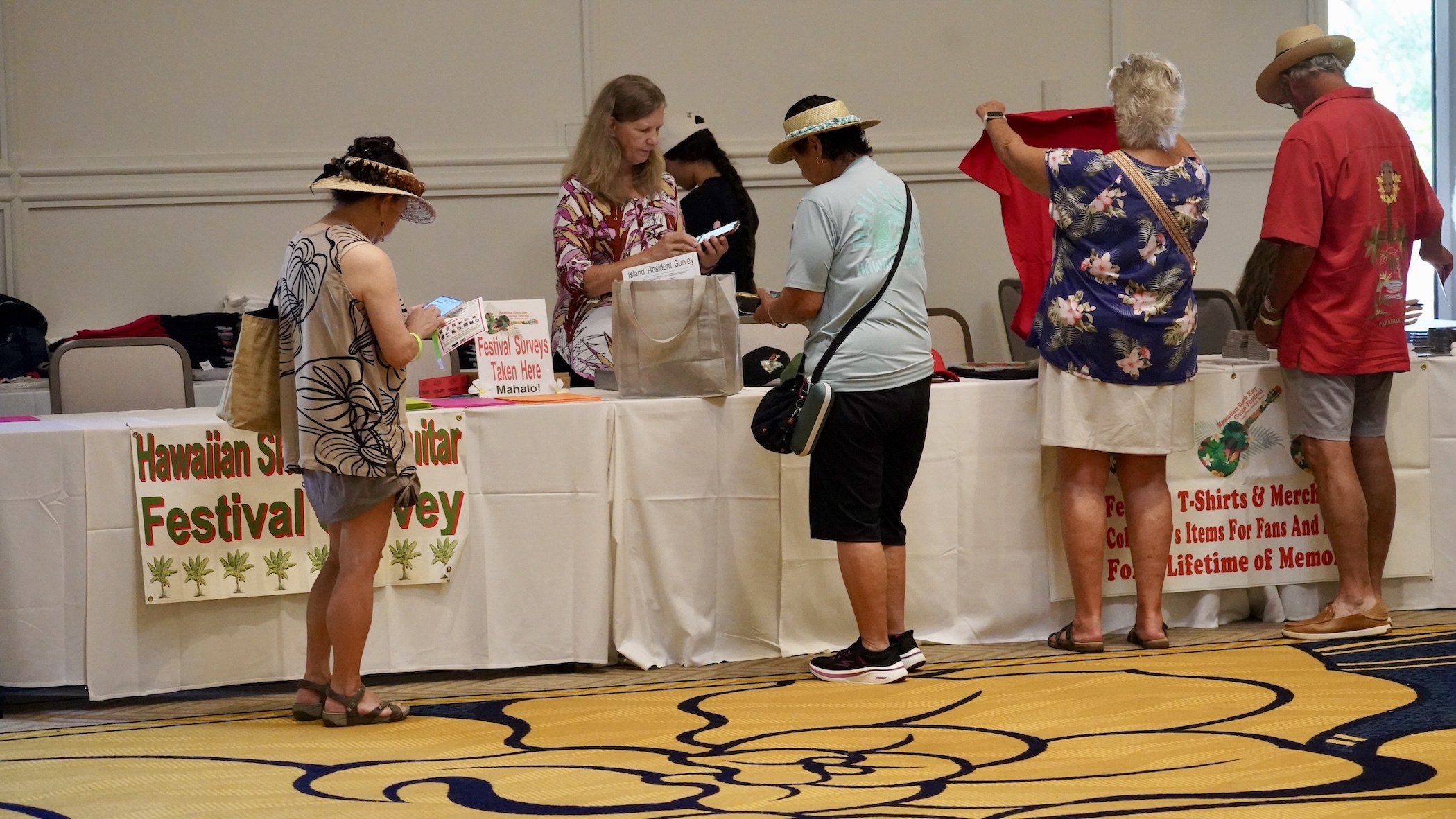 Anne Lau sells shirts and CDs at the 29th Annual Hawaiian Slack Key Guitar Festival- Kona Style on Sunday, Oct. 18.