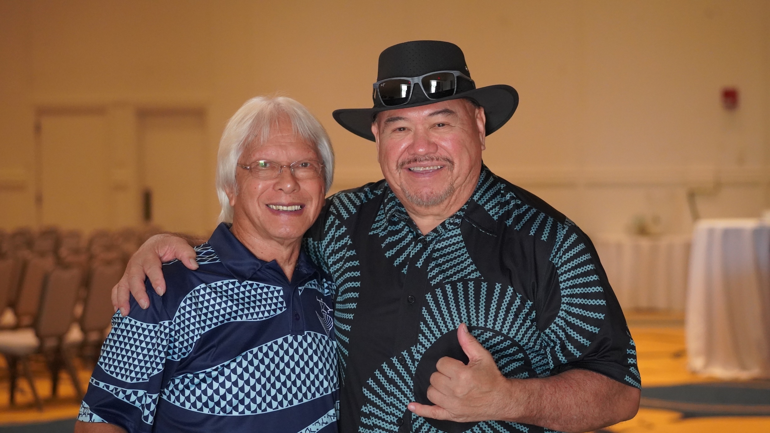Before the festival starts, Milton Lau, left, and Sonny Lim, catch up at the 29th Annual Hawaiian Slack Key Guitar Festival - Kona Style on Hawaiʻi Island, on Sunday, Oct. 18.