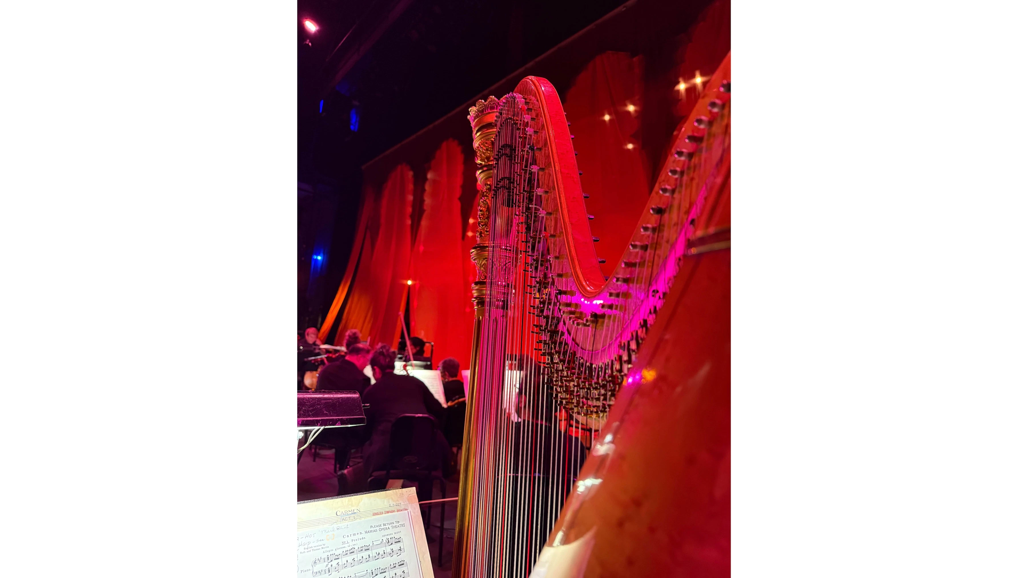 Constance Uejio’s harp got dramatic red lighting during the orchestra’s performance of “Carmen.”