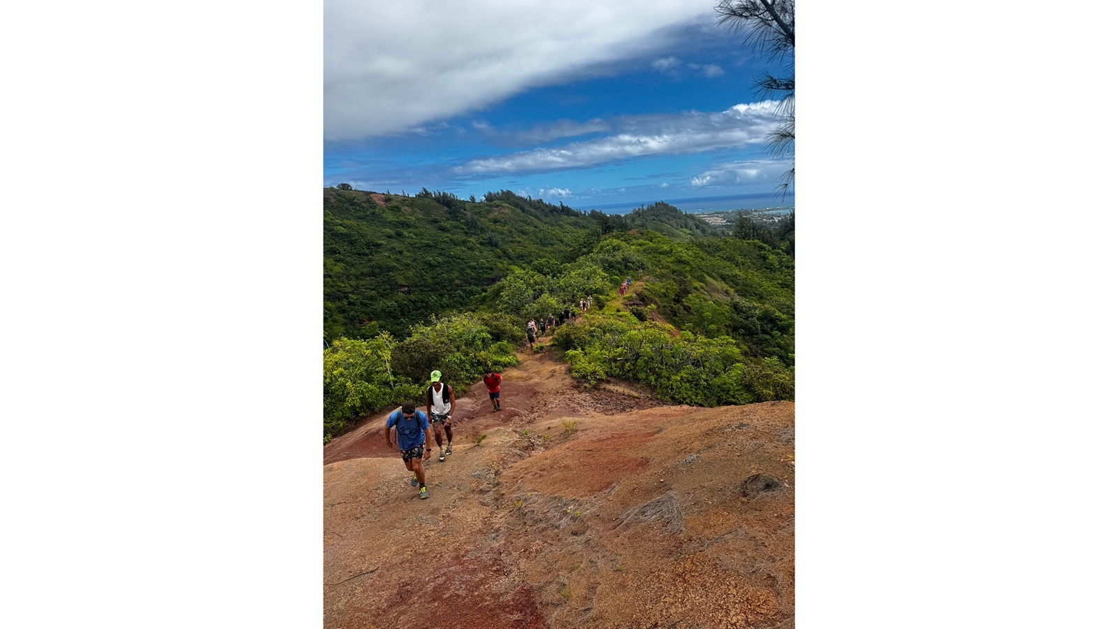 Wearing a neon green hat, Shilo Garner leads a Honolulu Hiking Club weekly hike.