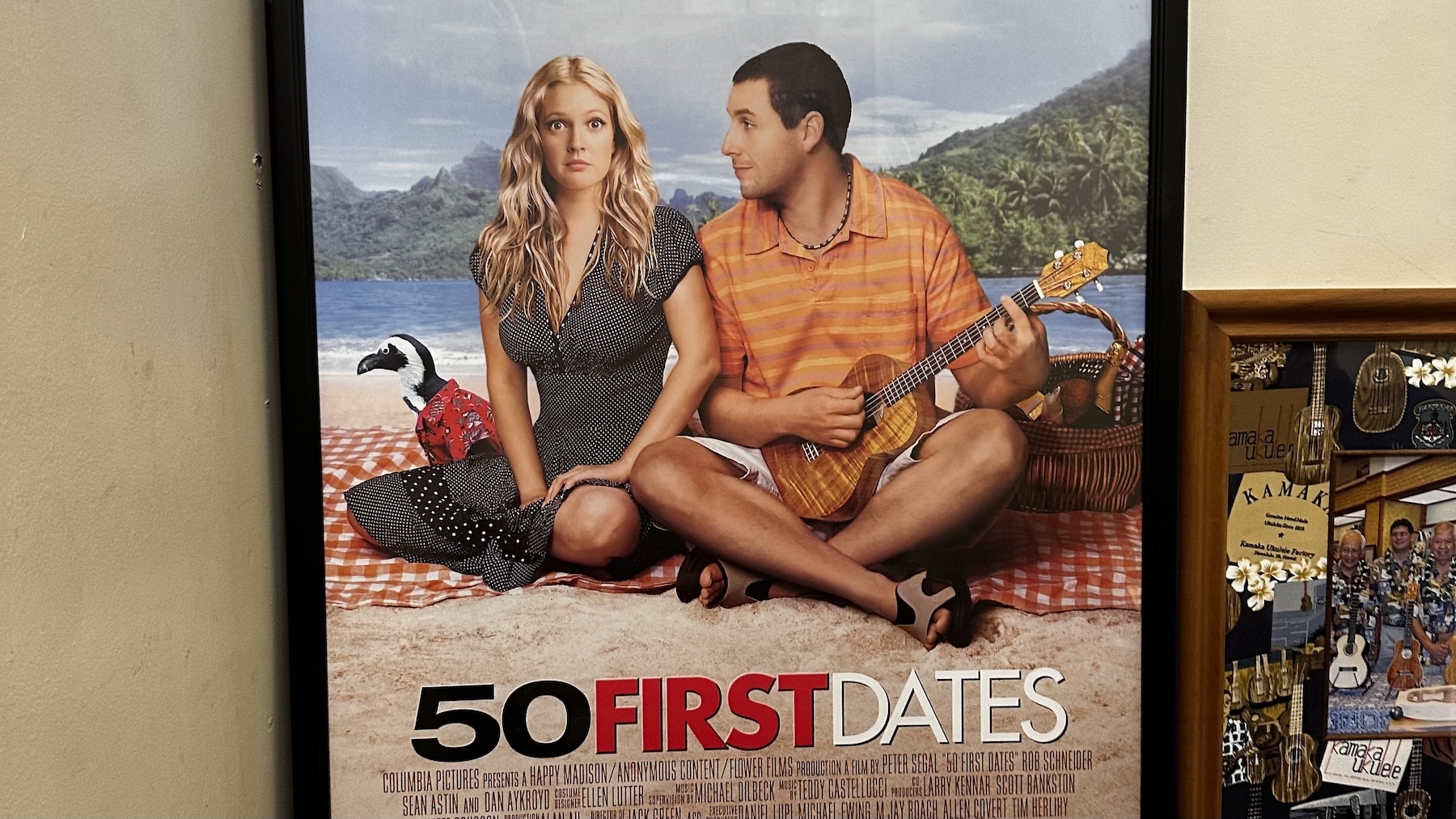 This movie poster featuring Adam Sandler and Drew Barrymore in "50 First Dates" features a custom instrument made by Kamaka ʻUkulele.