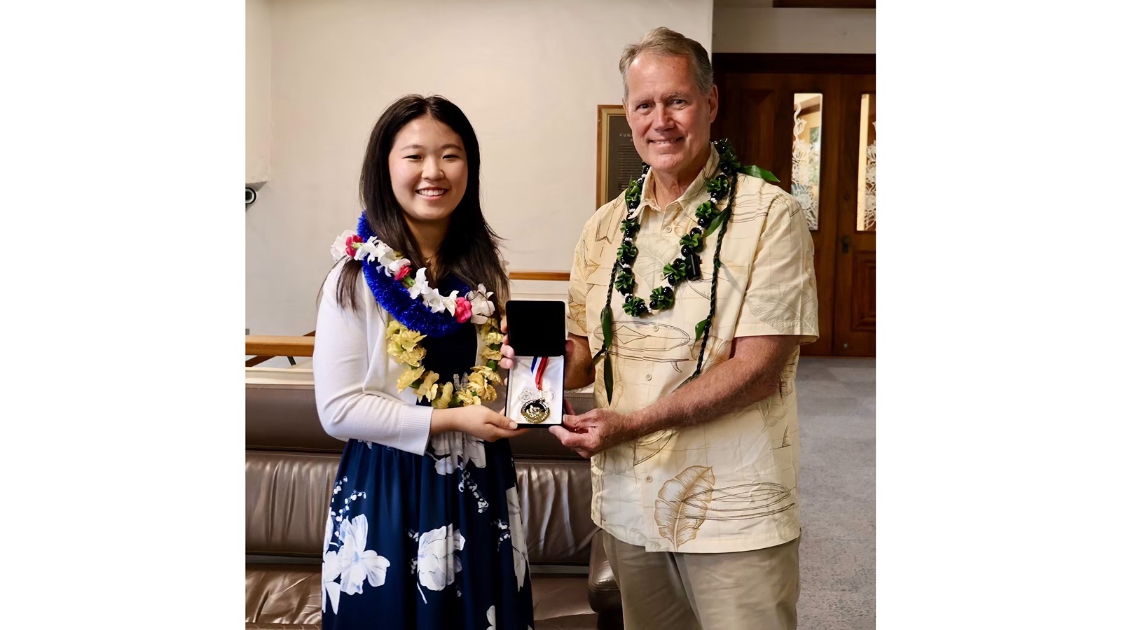 Congressman Ed Case presents Punahou School student Jessica Lee with the Congressional Award Gold Medal in August.