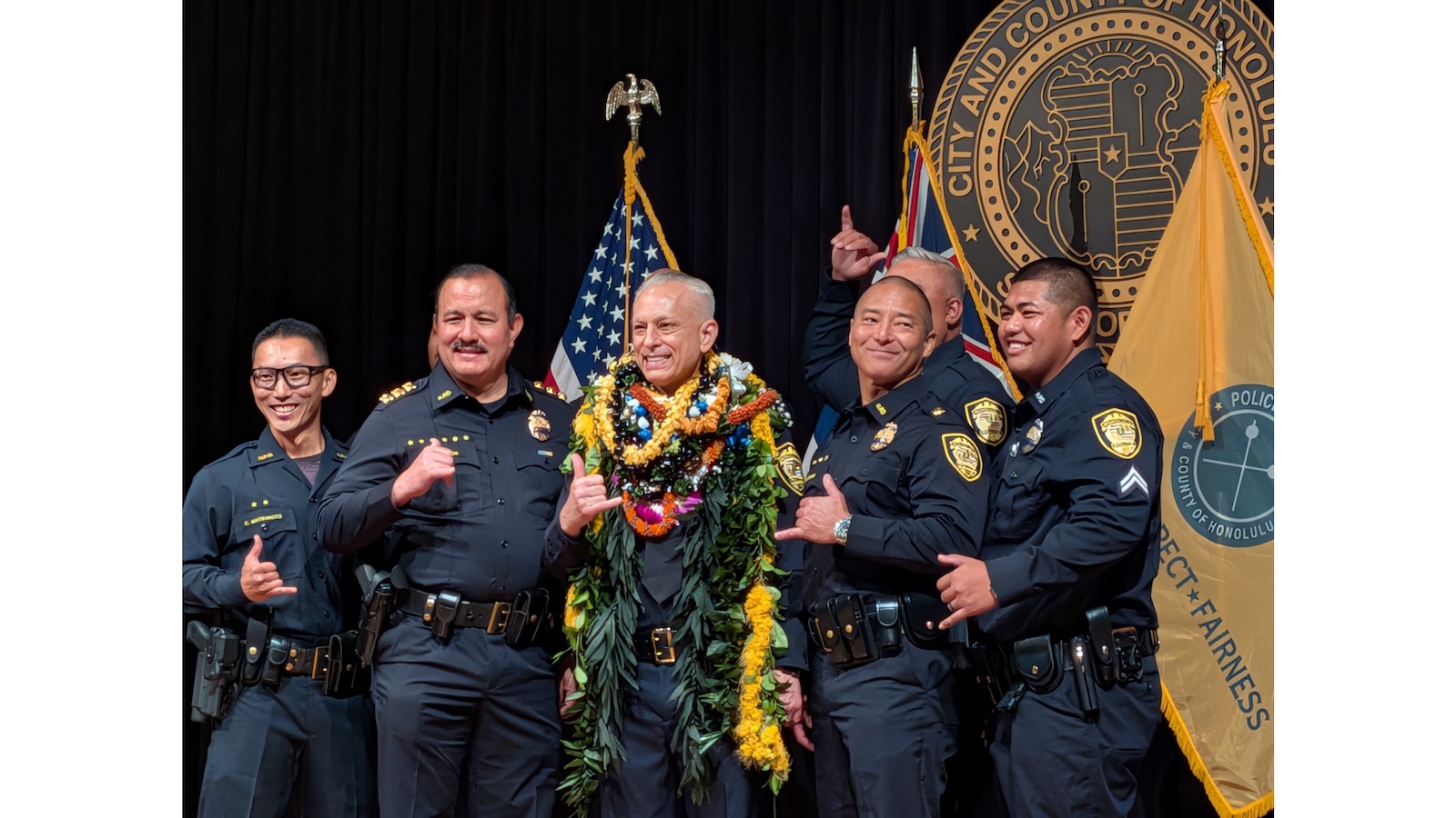 David Lazar, newly sworn in as Chief of Police, flanked by HPD officers.