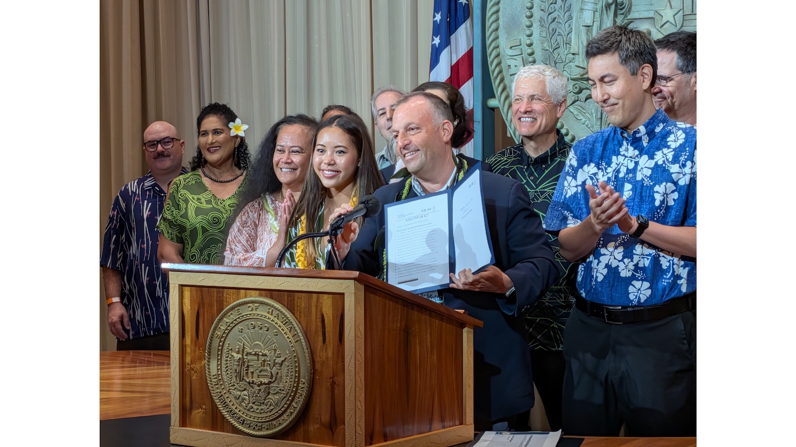 Gov. Josh Green and others celebrate the signing of an anti-vape bill into law.
