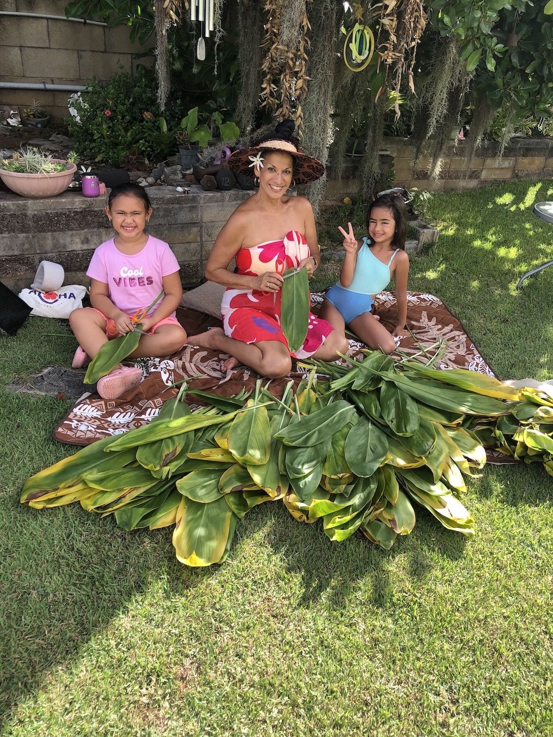 Puamana Garcia is teaching her grandkids the art of lei making.