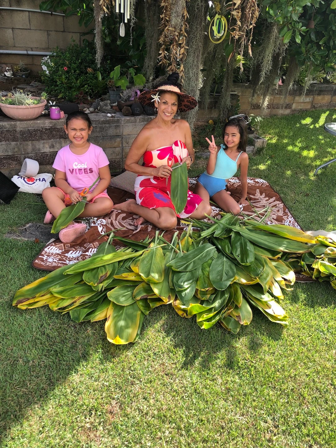 Puamana Garcia is teaching her grandkids the art of lei making.