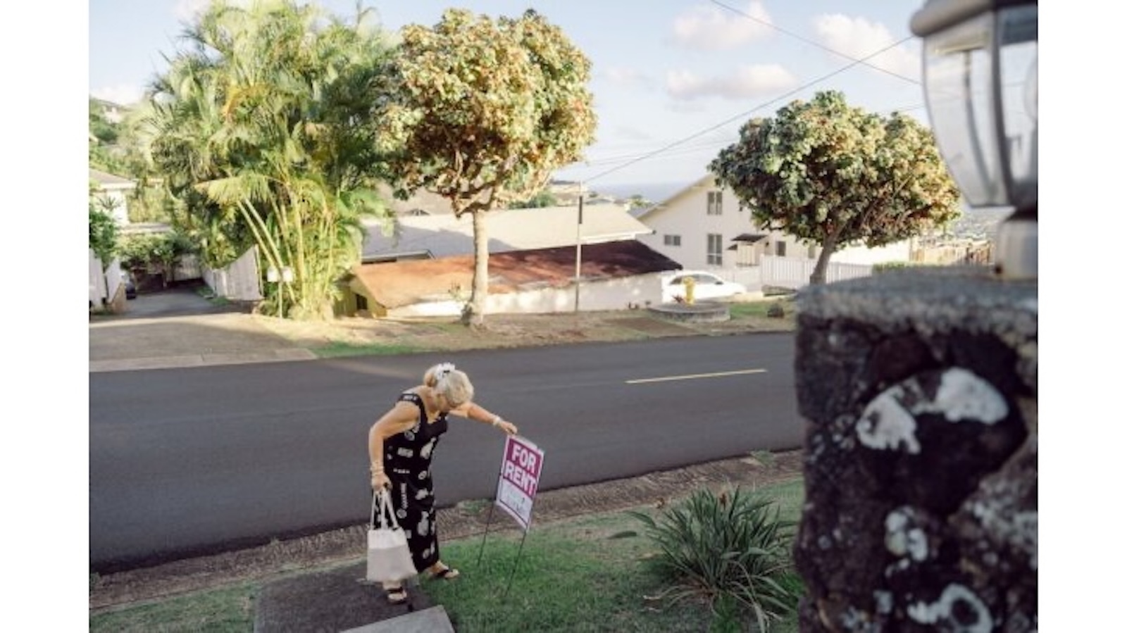 Sandra May puts up a "For Rent" sign outside her Wilhelmina Rise property. Her attorney Loren Seehase said this is her only means of advertising after online rental listings have incurred thousands of dollars in fines.