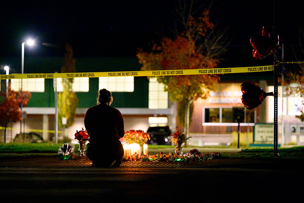 BEND, OREGON - OCTOBER 15: A woman grieves at a candlelight memorial out front of Silver Rail Elementary School on October 15, 2026 in Bend, Oregon. At least four victims were reportedly killed at the school in a mass shooting earlier today, the alleged gunman is also dead. (Photo by Mathieu Lewis-Rolland/Getty Images)