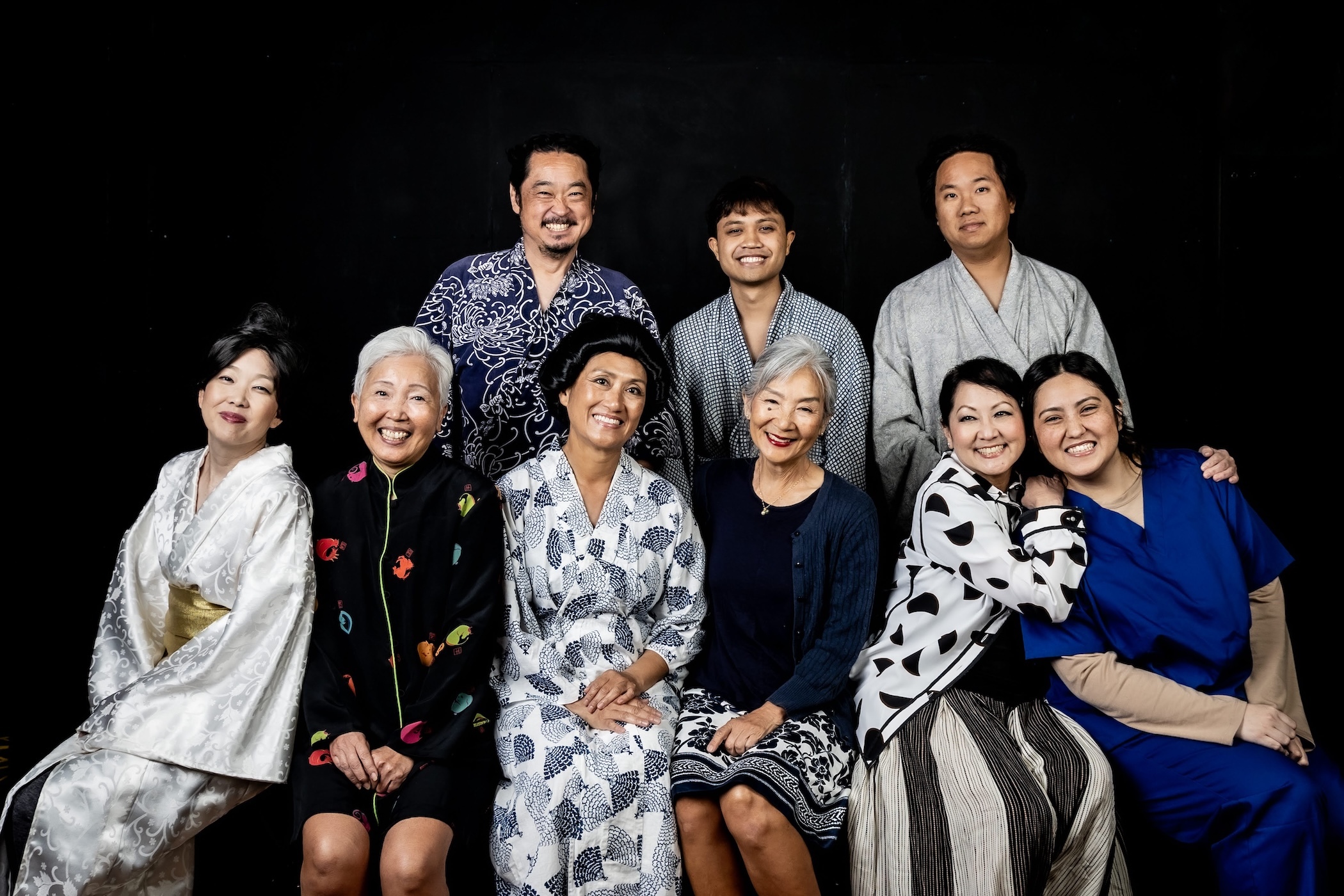 The back row, from left to right, includes: Stu Hirayama, Camden Colipano and Matthew Nakamura. The front row, from left to right, features Krist10 Misaki, Joy Turbeville, Pauli Amornkul, Denise Aiko Chinen, and Kirstyn Trombetta. Not pictured is Gabriella Gualano