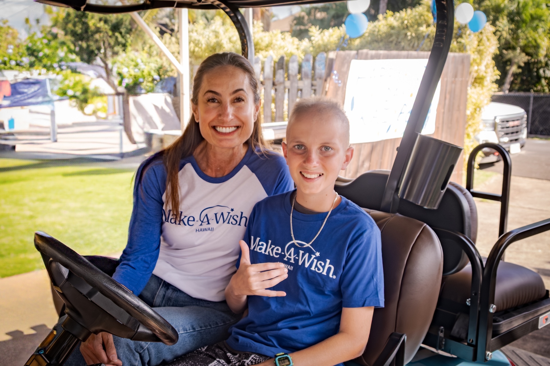 Trini Clark pictured with a wish kid, Kainoa.