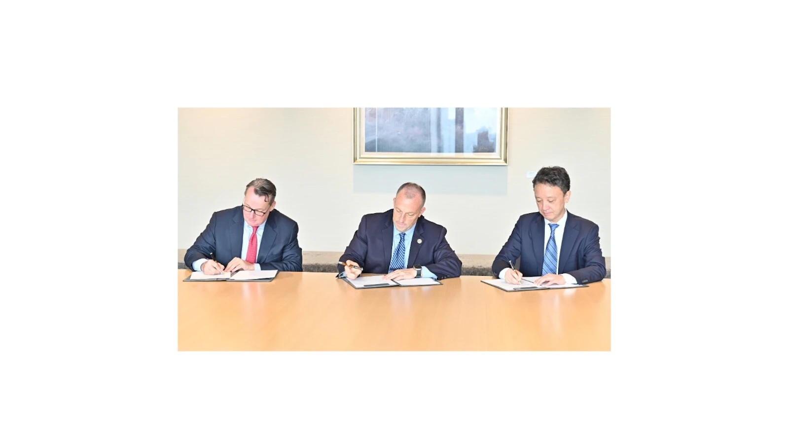 Gov. Josh Green signs a strategic partnering agreement in October, flanked by JERA Americas Inc. board chairman Steven Winn (left) and JERA Global CEO Yukio Kani.