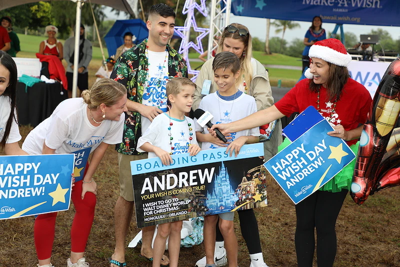 Clark, right, pictured at a wish reveal at fundraiser Jingle Rock Run in 2022.