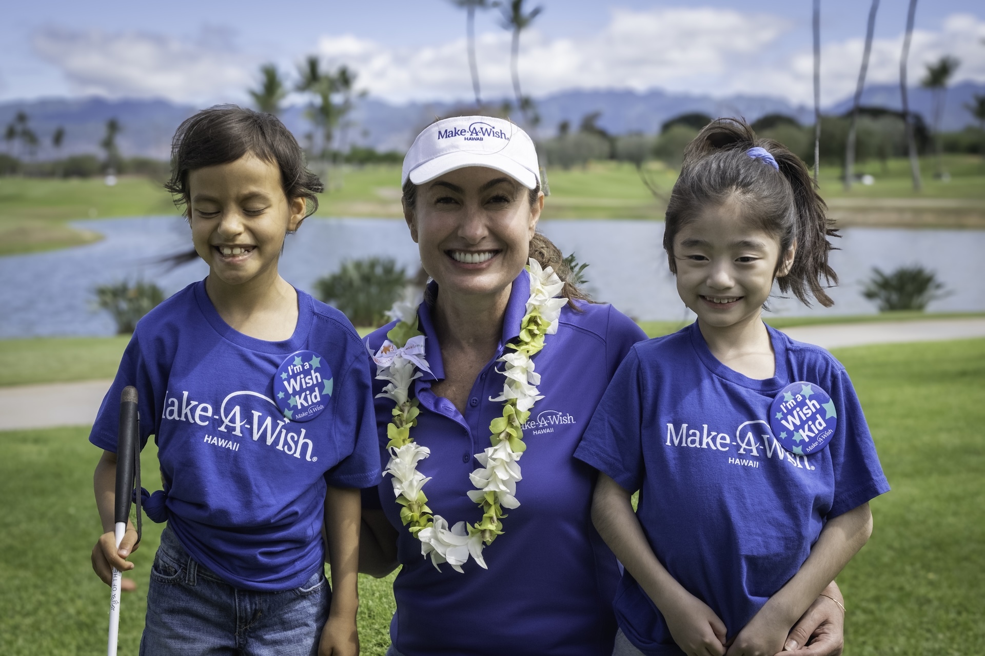 Clark pictured with wish kids at Swing for Wishes fundraiser.