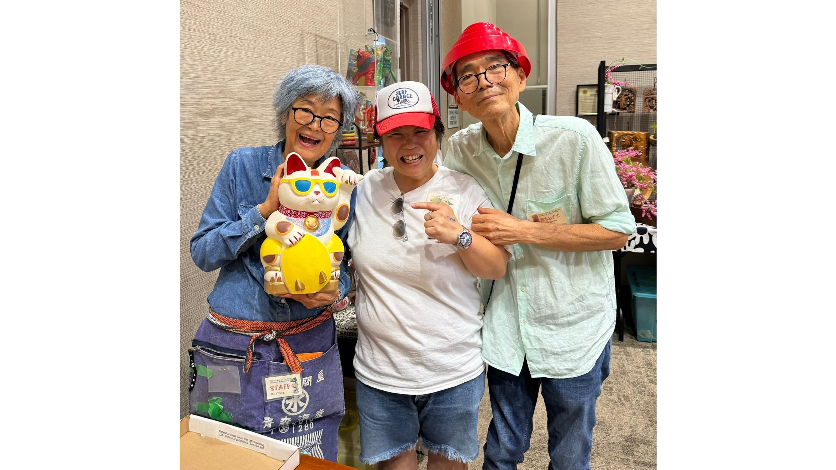 Ilene Wong and Wayne Maeda congratulate a customer (center) who flew from Tokyo to buy a Bumboocha Shaka Cat at the fall show last year. Such Mejiro Enterprises ceramics, made by the couple beginning in the early 1980s, are now considered vintage collectibles.